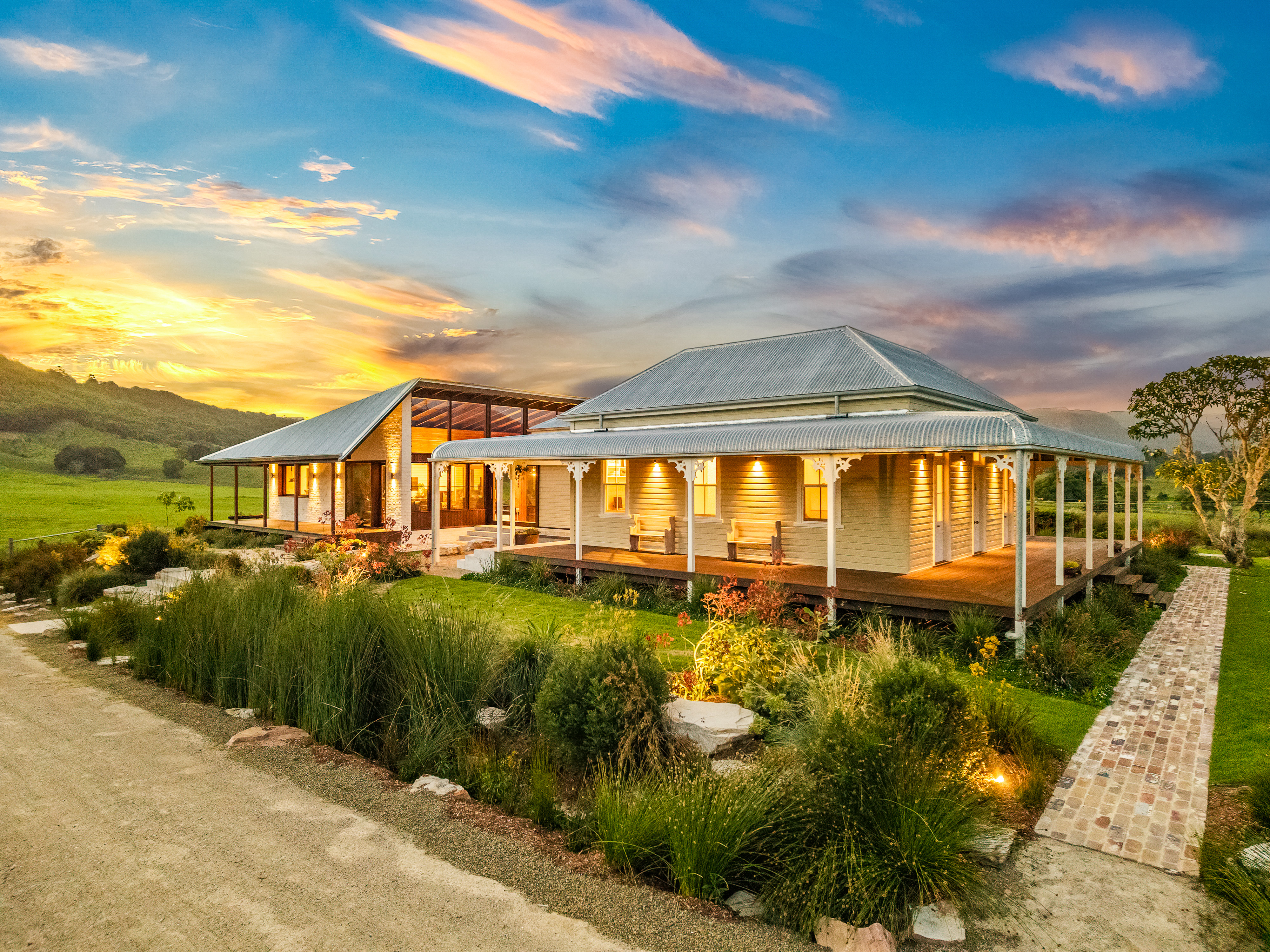 Longfield homestead at twilight with dramatic sunset sky