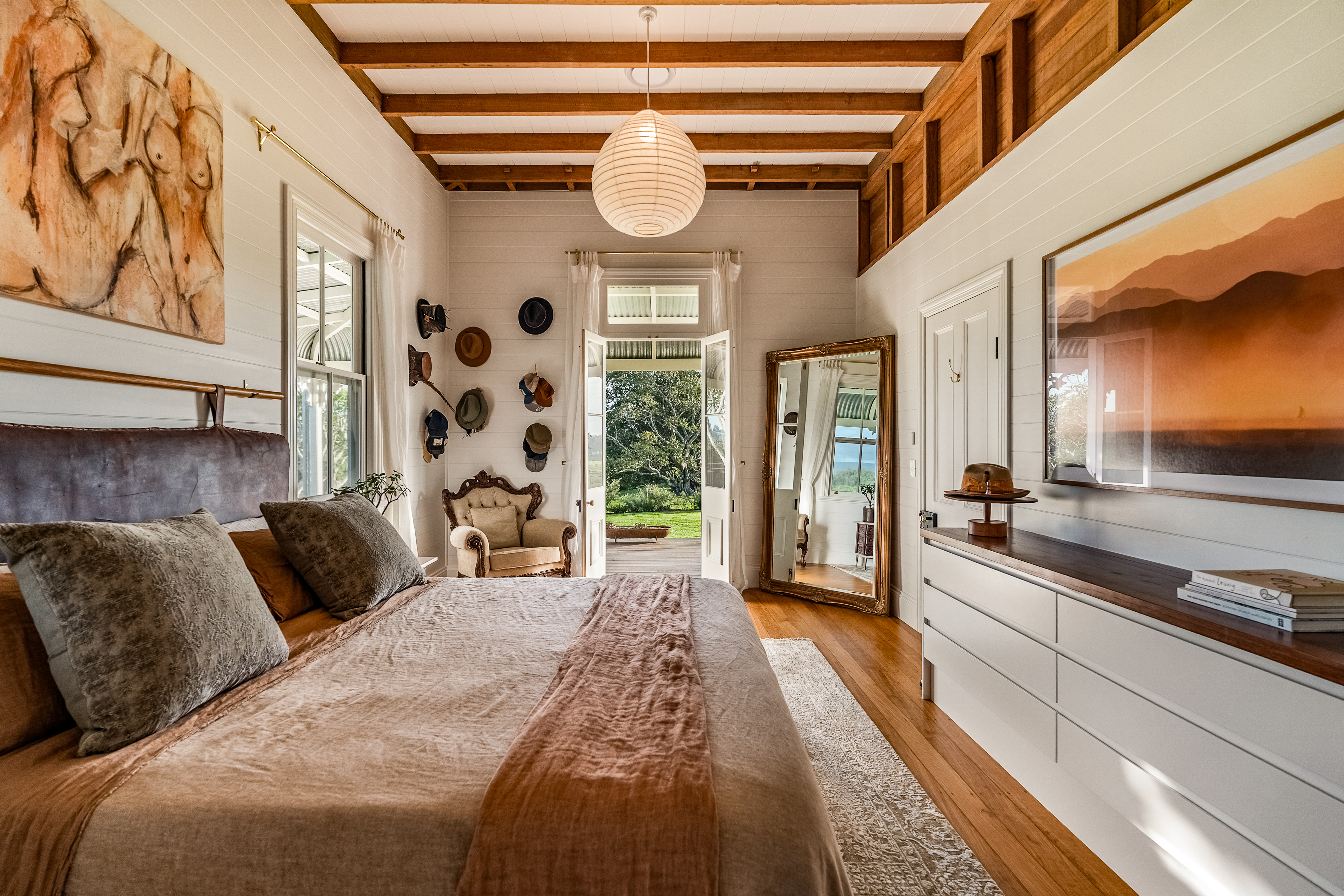 Master bedroom with exposed beams, French doors and pastoral views