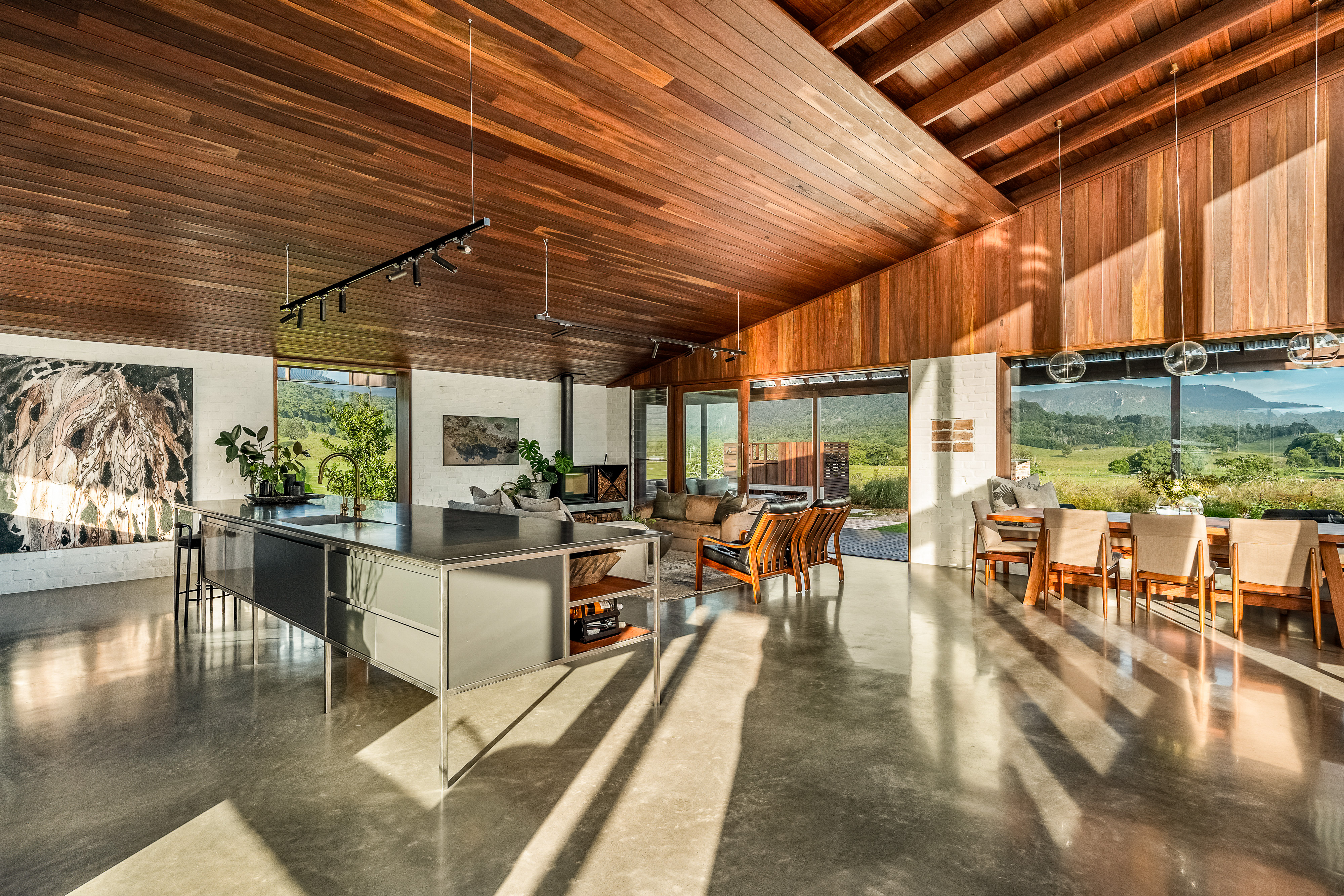 Kitchen and living from extension with polished concrete and mountain views
