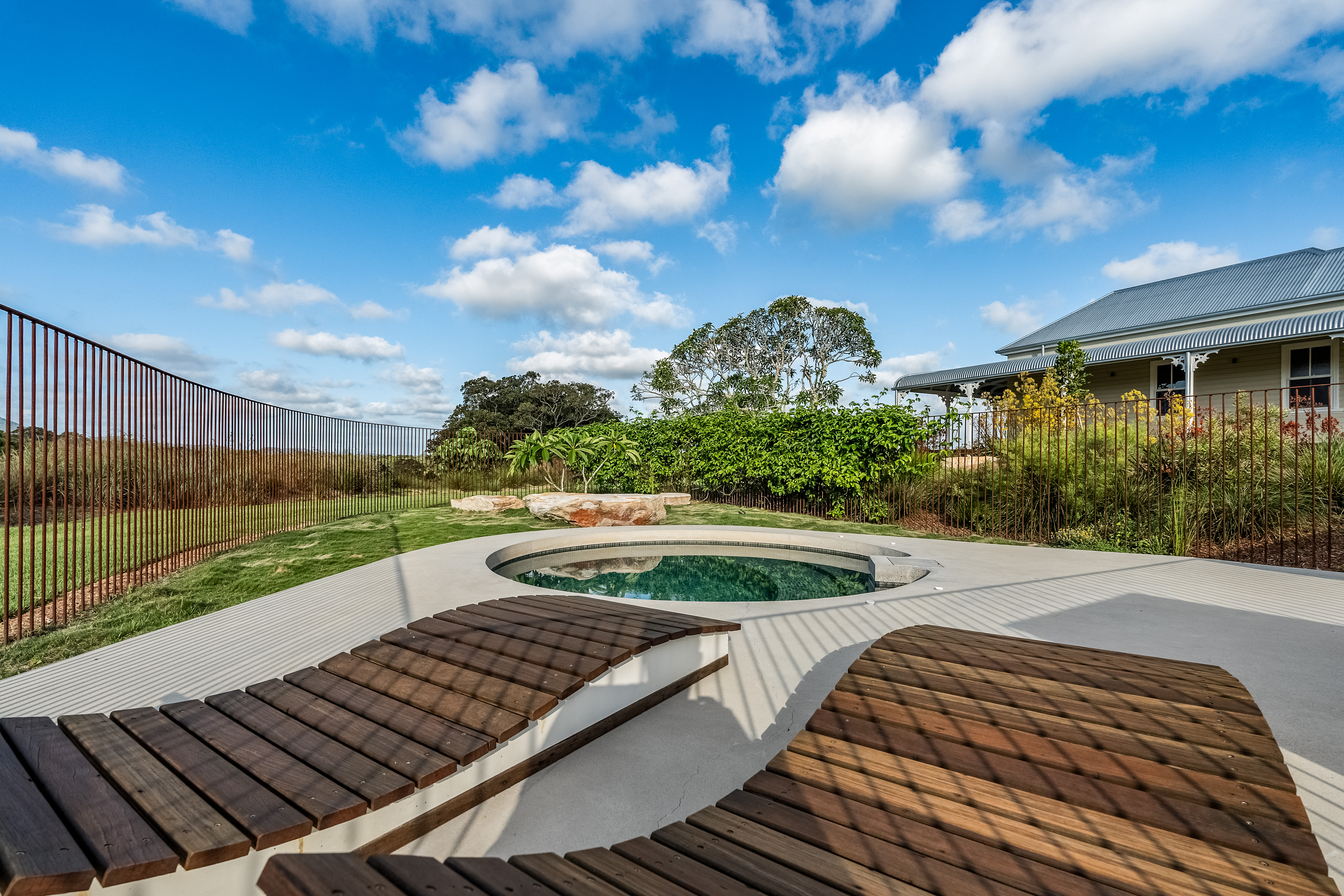 Pool area with heritage homestead in background