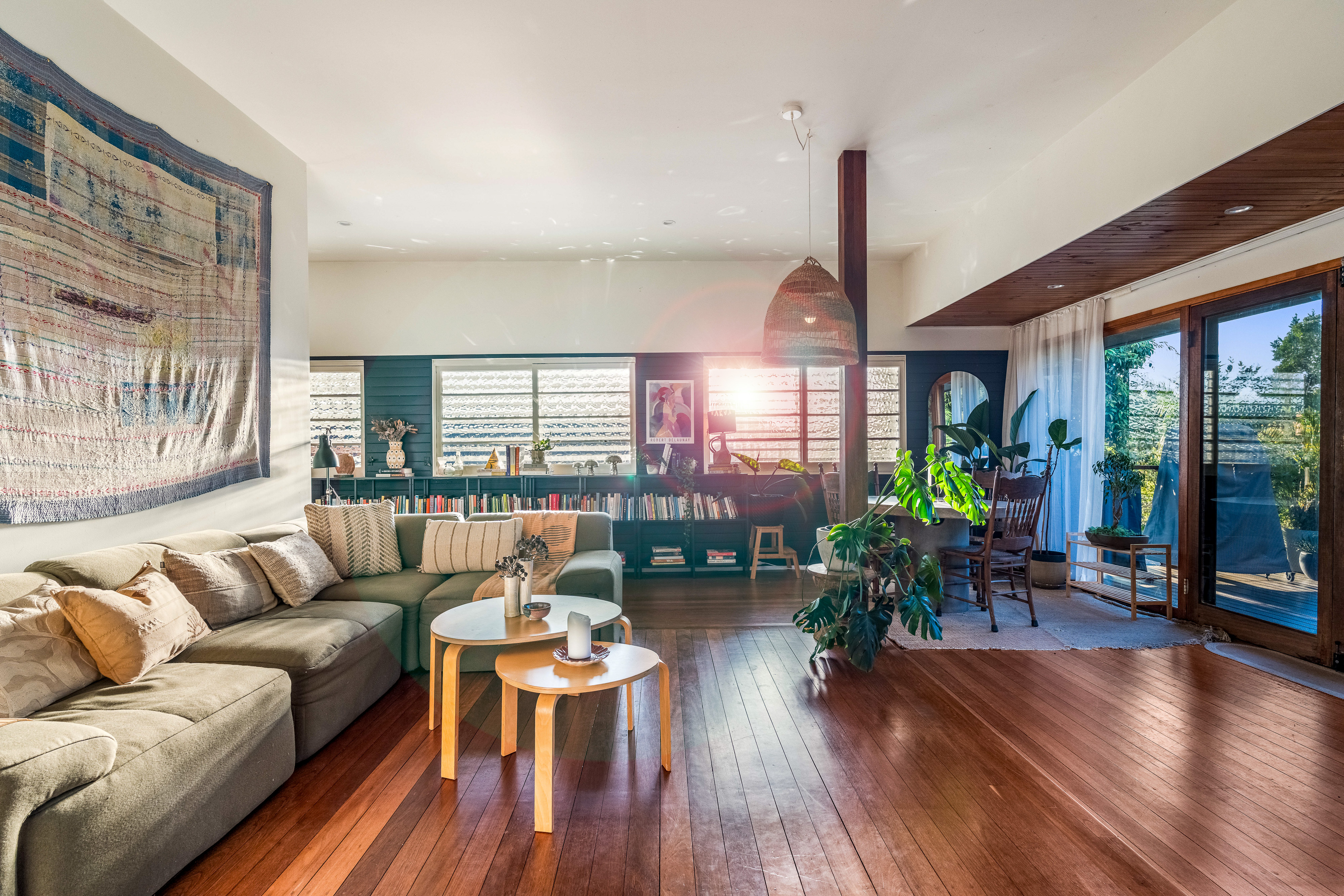 Living room with sunset flare through louvre windows