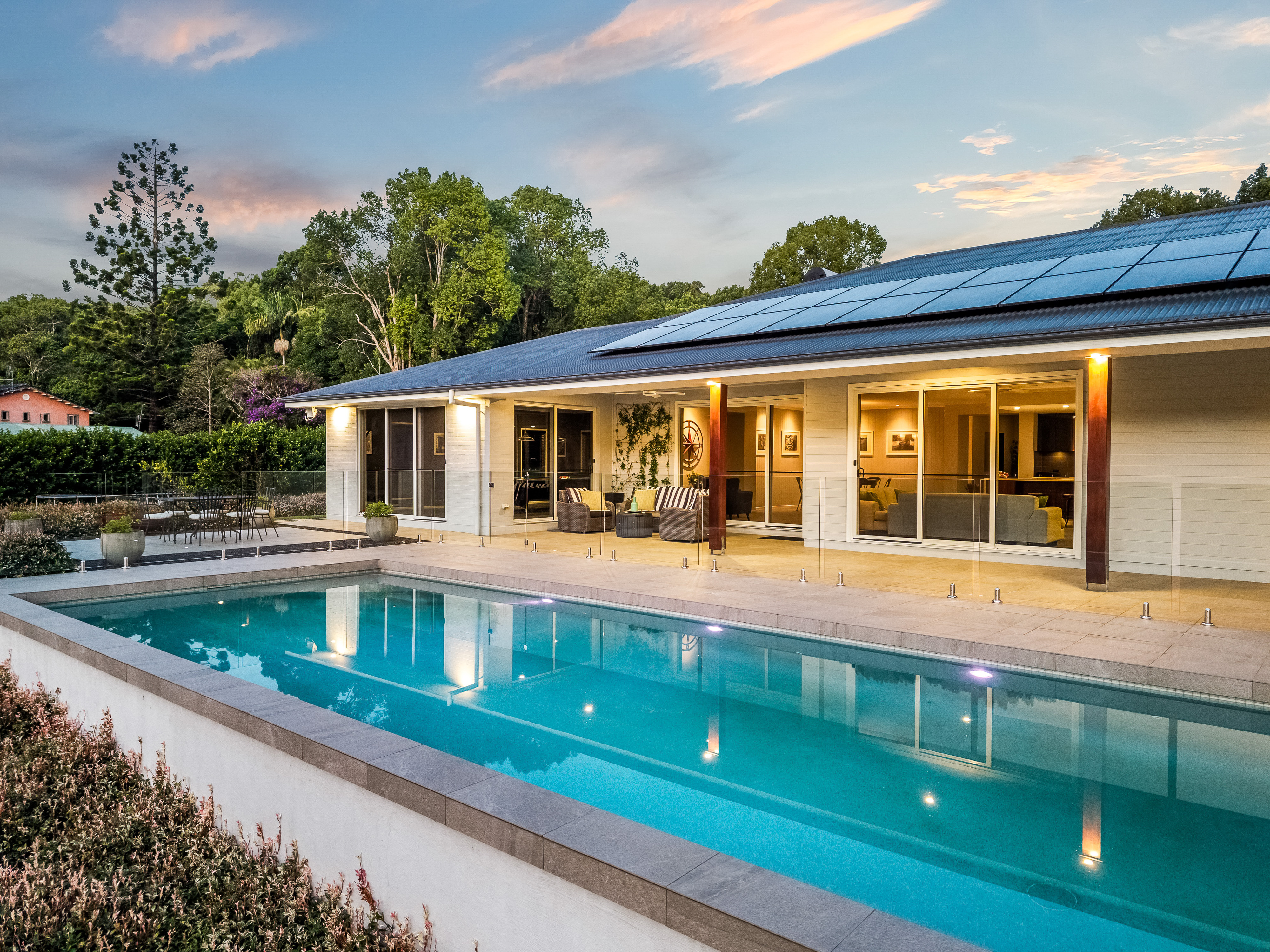 Pool at twilight with house glowing — twilight property photography Tintenbar Northern Rivers