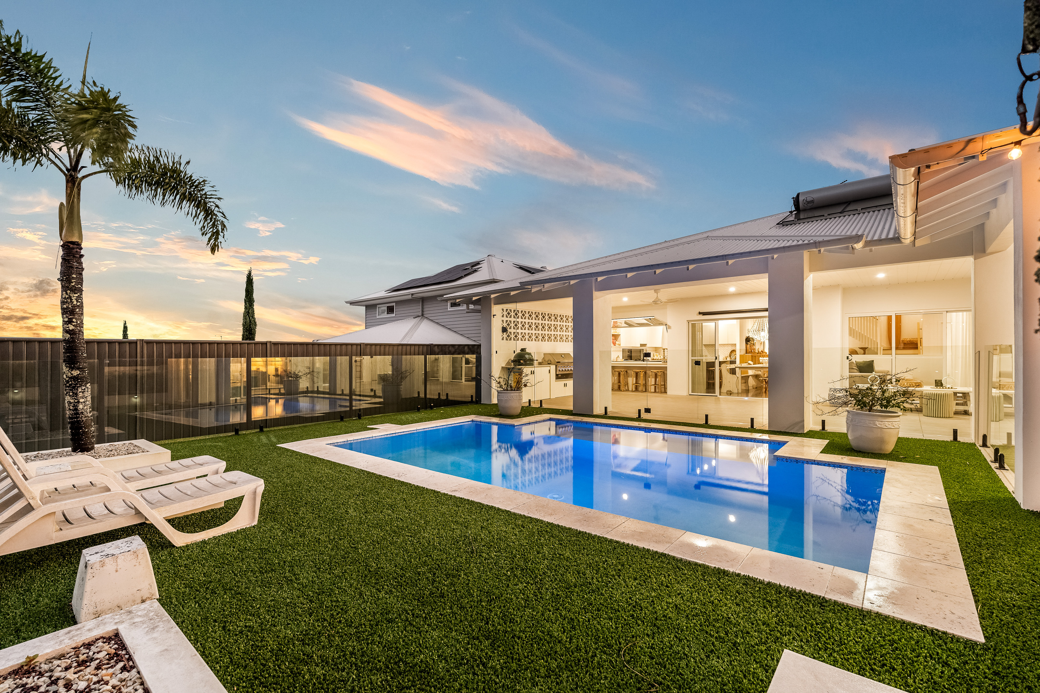 Pool and backyard at twilight with festoon lights — twilight real estate photography Ballina