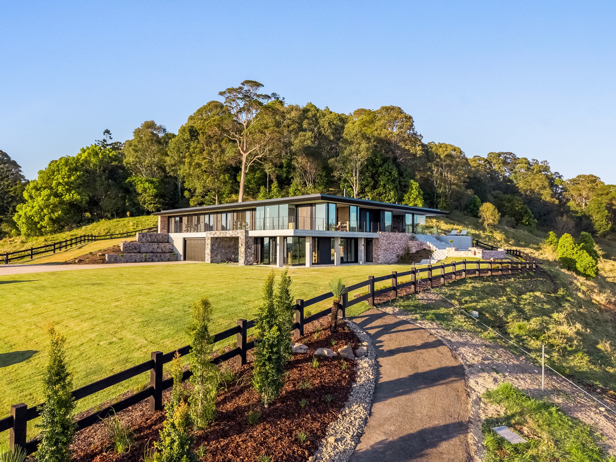 Aerial showing full property compound with front facade and driveway