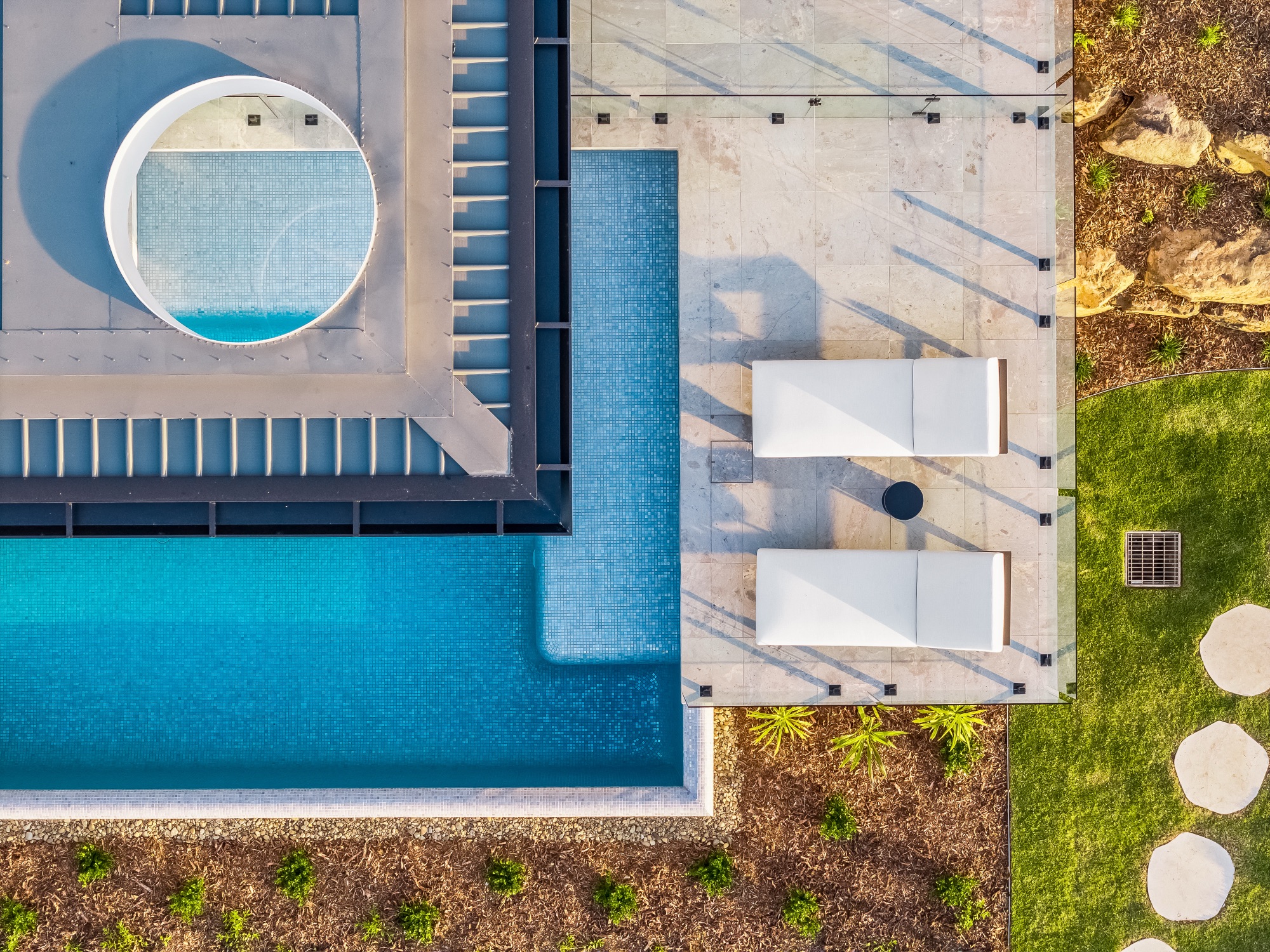 Nadir drone shot of pool, spa and sun lounges