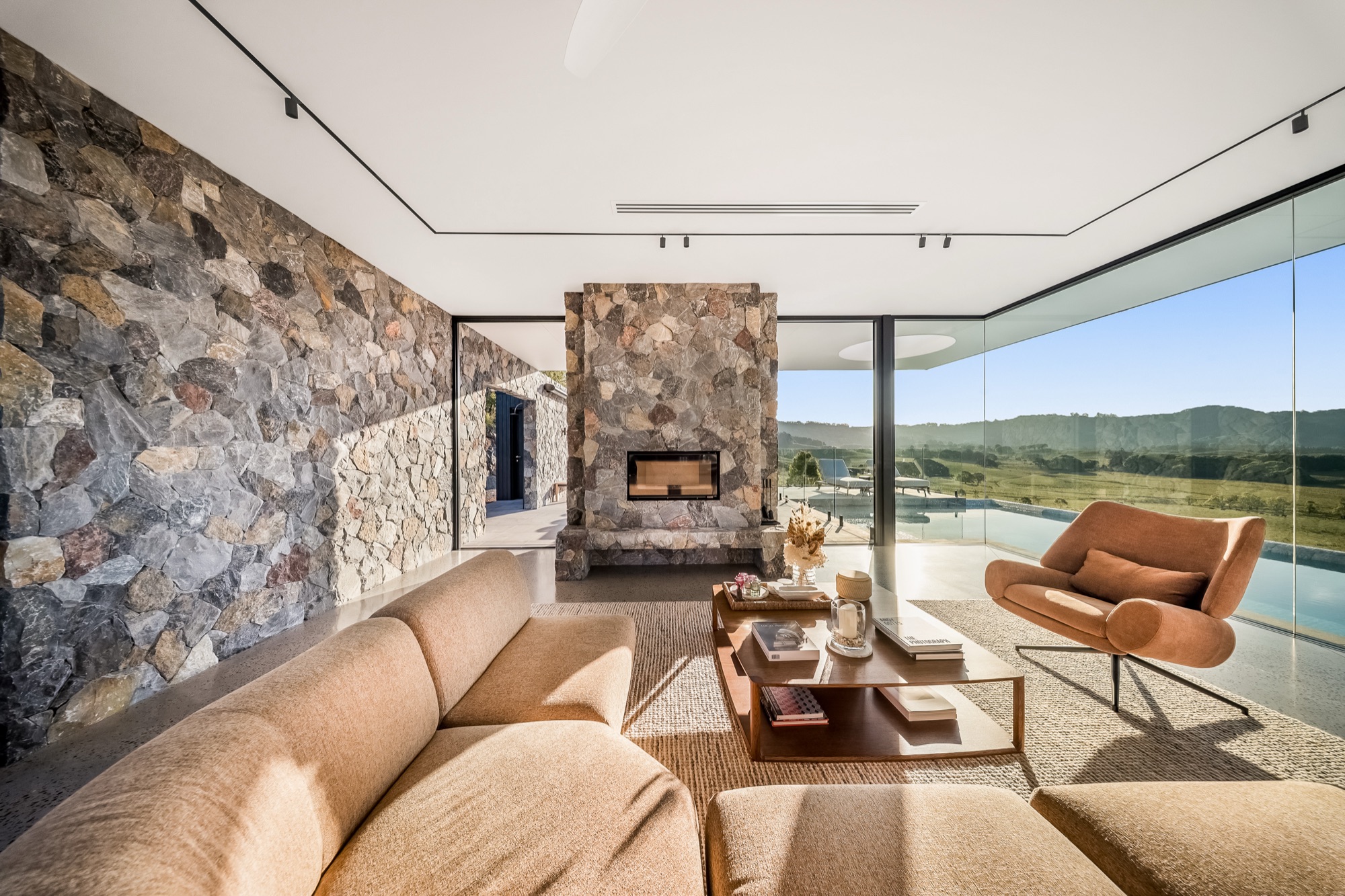 Courtyard with crazy paving, outdoor furniture and rock retaining walls