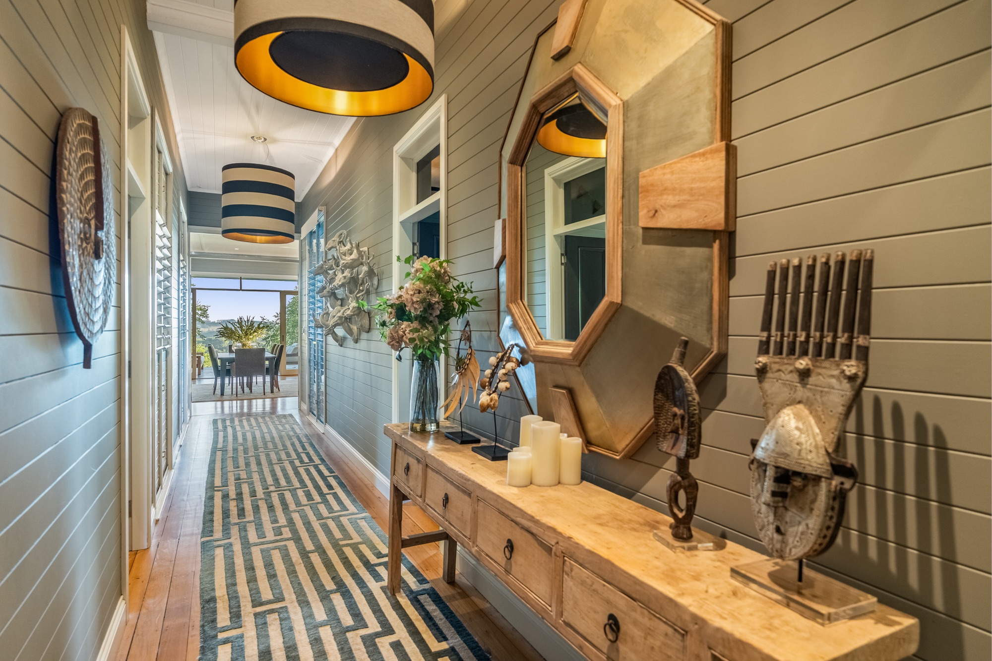 Hallway detail with timber console, octagonal mirror and collected objects