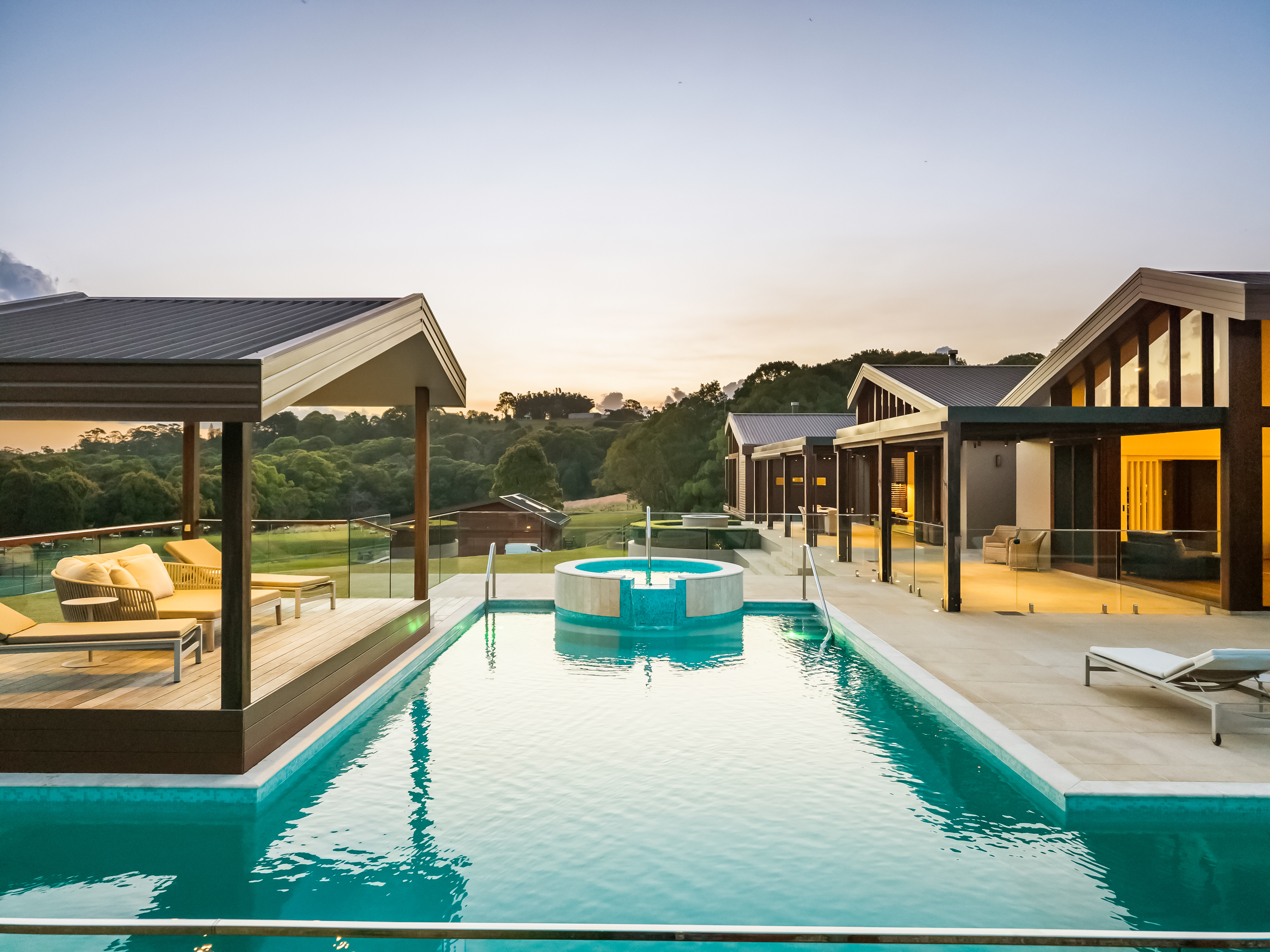Resort-style pool and spa at twilight with pavilion architecture — twilight property photography Northern Rivers