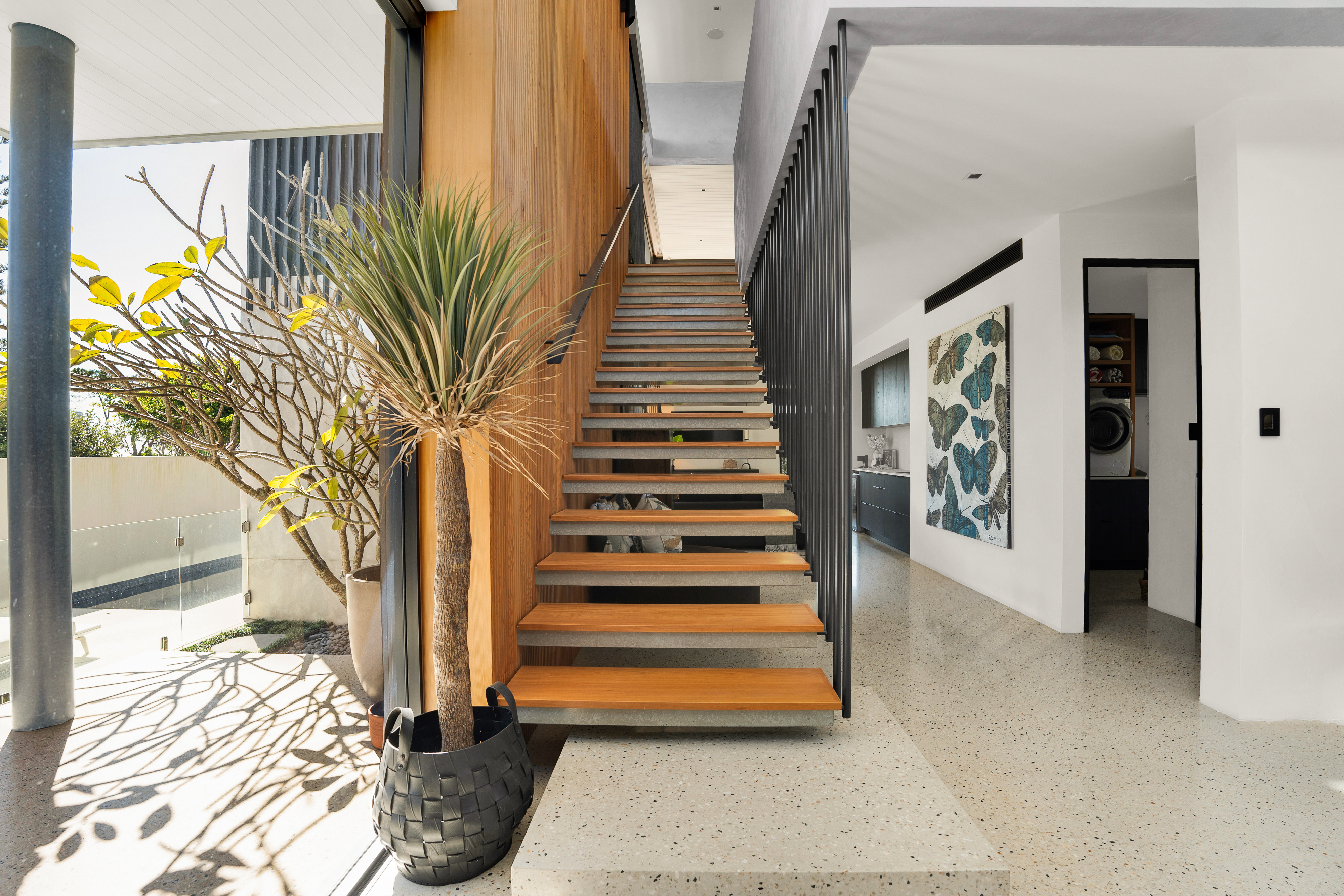 Floating timber staircase with internal courtyard — architectural photography Tweed Coast